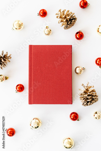 a red book on a white background with gifts, cones and Christmas toys. the concept of Christmas