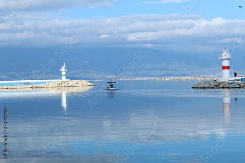 Pier. Lighthouse on the sea. Ida Mountain silhouette. Photo taken in iskele burhaniye town Aegean sea coast region Turkey anatolia asia. Calm warm weather day in winter december 2021 