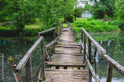A wobbly wooden bridge over the handle leading to the other side and into the village