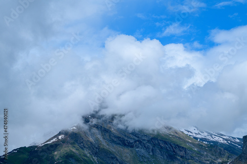 Clouds from the top of the mountain Roches Merles in Europe, France, the Alps, towards Chamonix, in summer, on a sunny day.