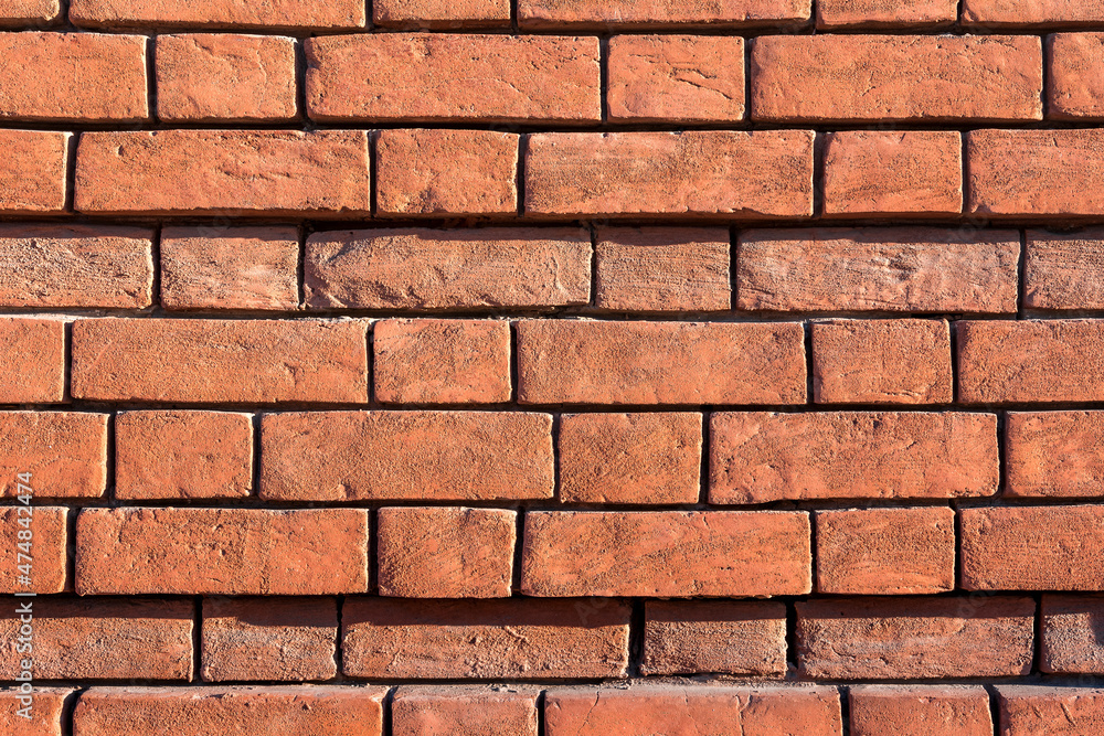 Ancient red brick masonry on the wall of a residential building. Natural stone background and texture. Ancient red brick masonry on the wall of a residential building. Natural stone background and texture.