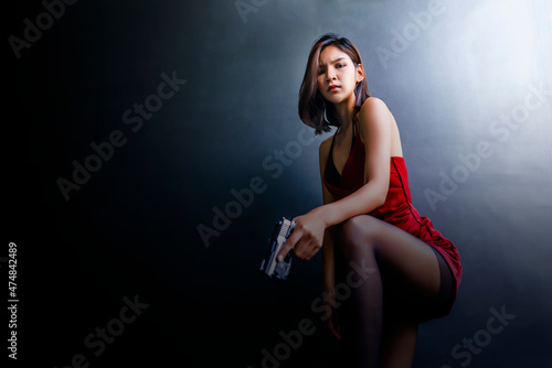 Woman in red aiming a gun