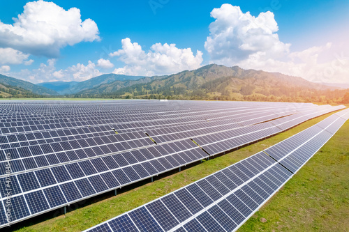 Solar panels on sunny day aerial top view sun light. Power farm producing clean green energy