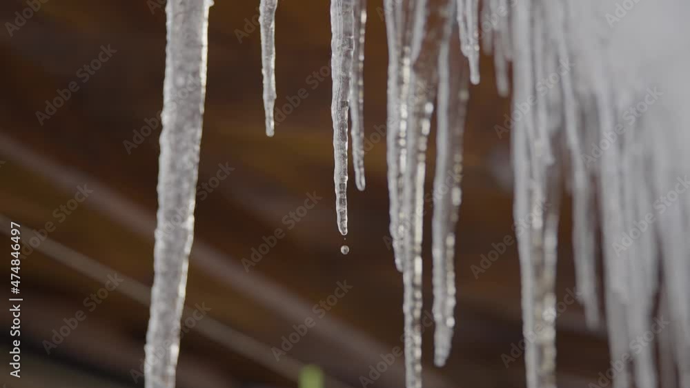 Ice spikes melting in slow motion at wintertime with camera movement Ice spikes melting in slow motion at wintertime with camera movement