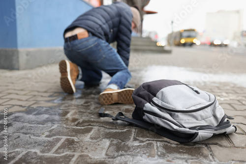 Принти на полотні Man get up from ground after falling on slippery asphalt in winter