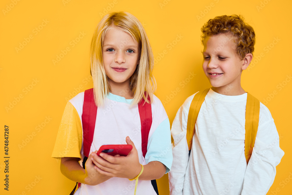 teenage boy and girl talking and smiling emotions joy yellow background