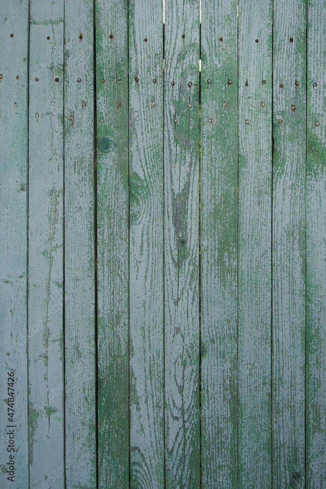 texture of a wooden fence. fence painted green. peeling paint on an old fence. old wood texture. photo can be used as a photophone, as a texture texture of a wooden fence. fence painted green. peeling paint on an old fence. old wood texture. photo can be used as a photophone, as a texture
