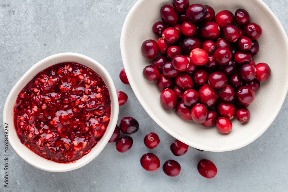 Red berries on a dark background. cranberries in a bowl. Red berries on a dark background. cranberries in a bowl.