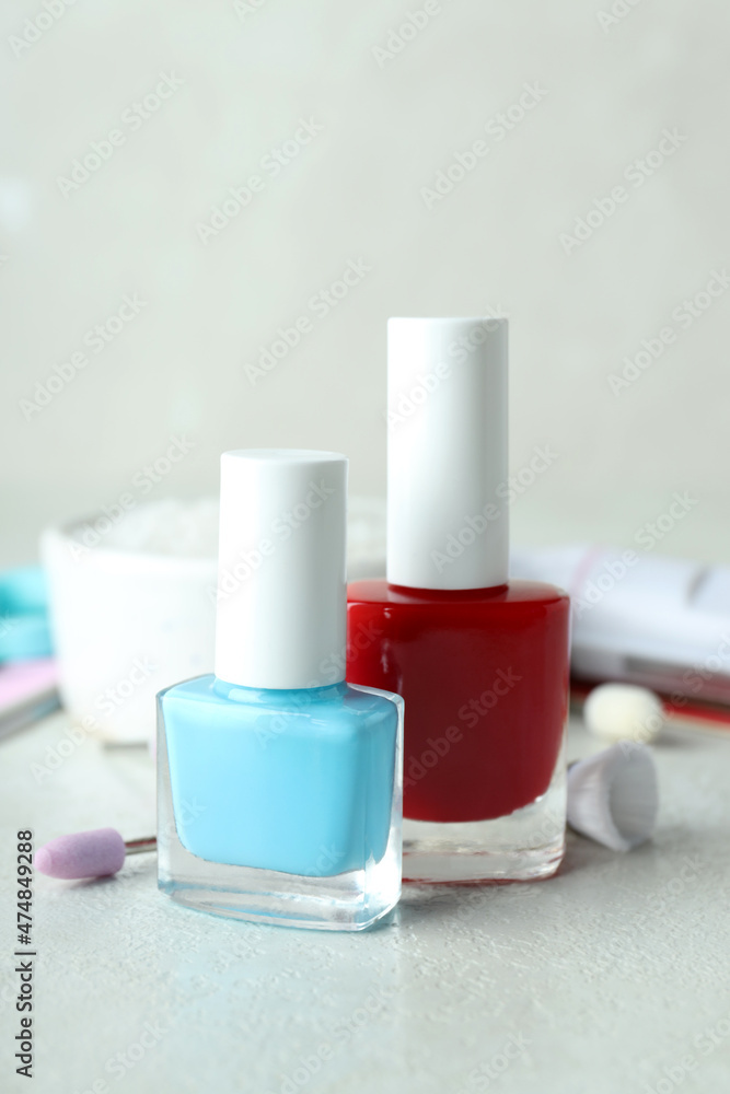 Concept of nail care with manicure accessories on light textured table Concept of nail care with manicure accessories on light textured table