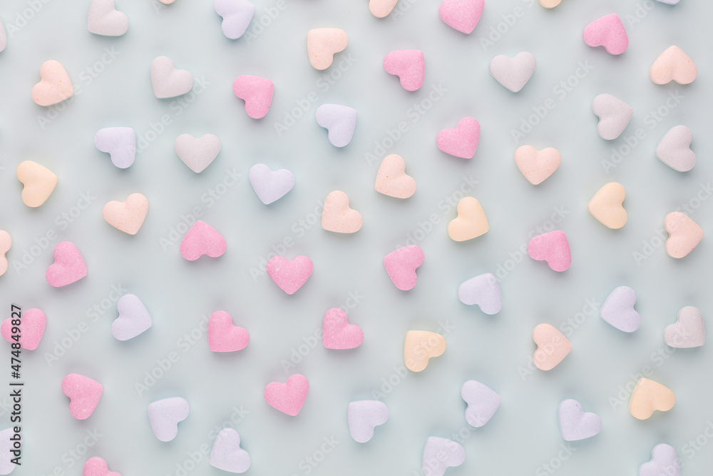 Composition with candy hearts on pastel blue background. Composition with candy hearts on pastel blue background.