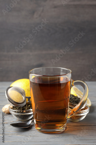 Concept of hot drink with tea on gray wooden table