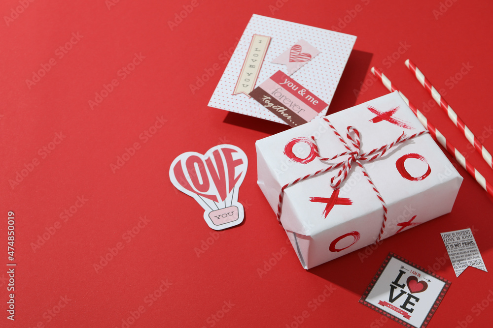 Valentine's Day accessories on red background, space for text