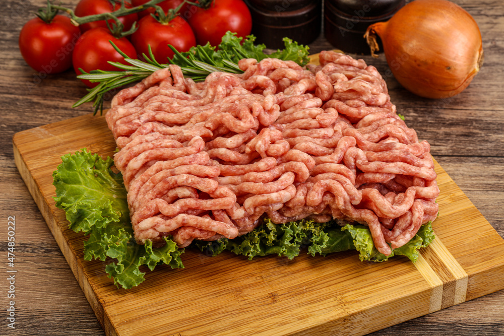 Raw pork minced meat over board Raw pork minced meat over board