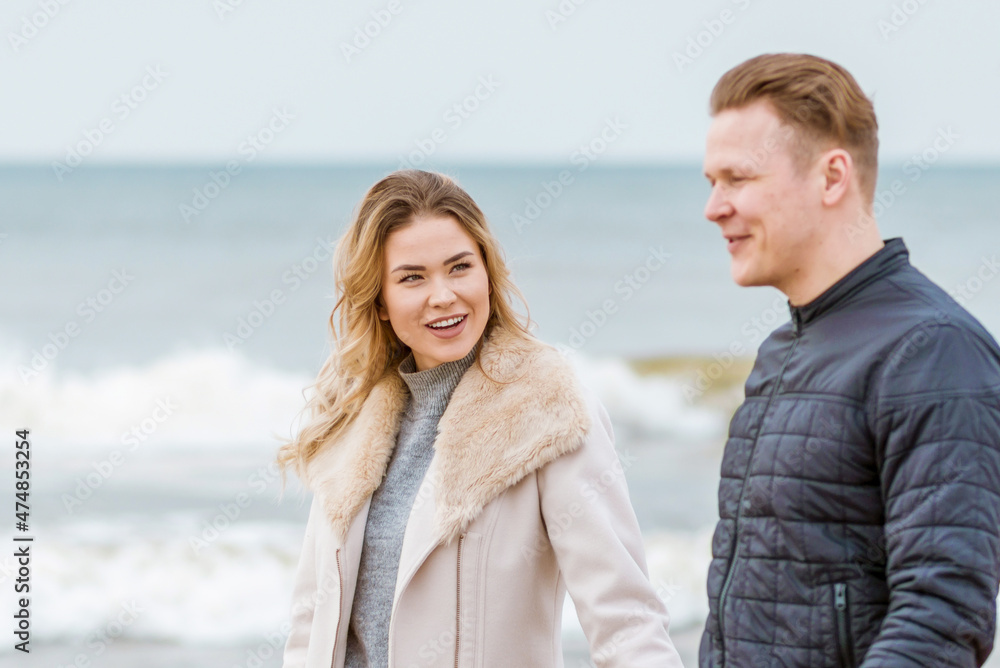 Obraz premium Young loving couple spending time together at spring beach.Blur background,close up.