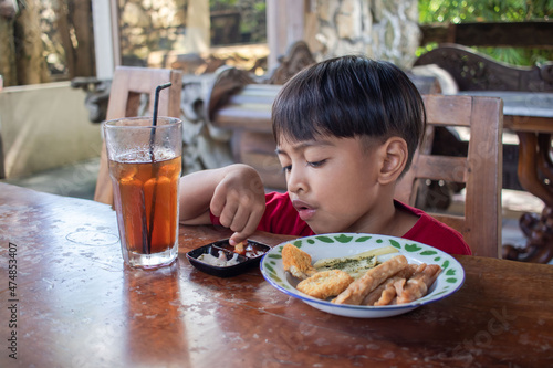 a boy is having breakfast snacks