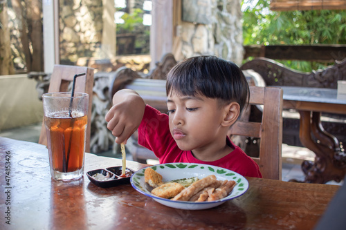 a boy is having breakfast snacks