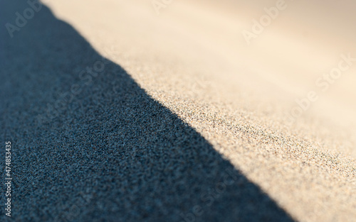 The border between light and shadow at the edge of a sand dune.