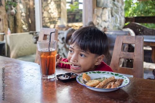 a boy is having breakfast snacks