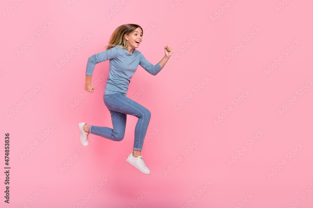 Full size profile side photo of young excited girl run energetic look empty space hurry isolated over pink color background Full size profile side photo of young excited girl run energetic look empty space hurry isolated over pink color background