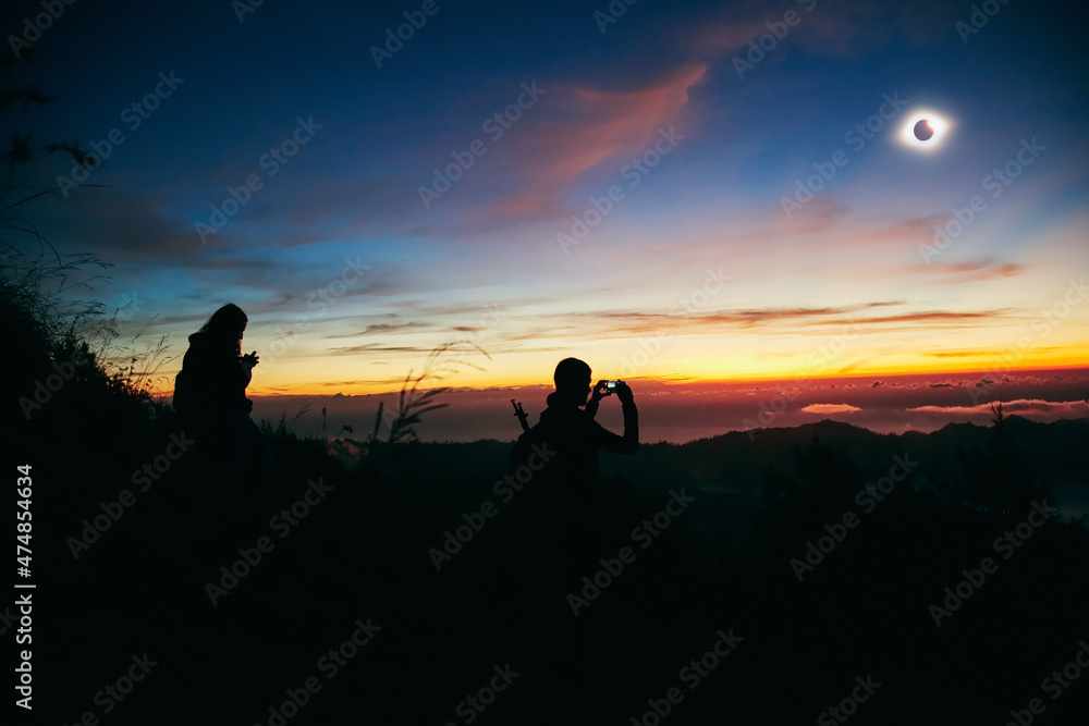 Solar eclipse on a colorful sky.