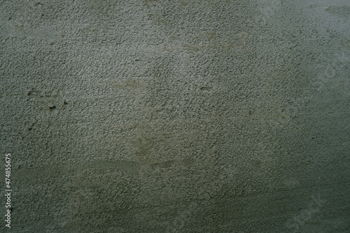 Surface of fresh cement plaster. Texture of gray wet plaster on the wall on construction site.