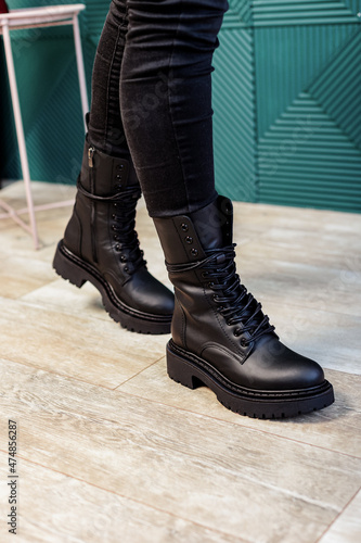 Female legs in black leather boots. New collection of winter boots for women © Дмитрий Ткачук