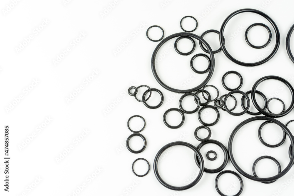 Black hydraulic and pneumatic o-rings in different sizes on a white background. O-rings for hydraulic connections. Rubber seals for sanitary ware. Copy space Black hydraulic and pneumatic o-rings in different sizes on a white background. O-rings for hydraulic connections. Rubber seals for sanitary ware. Copy space