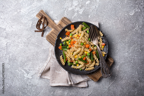 Plate of Italian rotini pasta with vegetables photo