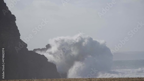 Slow motion of a wave break in Nazaré, Portugal. Wave breaking in front of Nazare lighthouse. photo