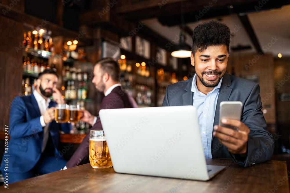 Portrait of a successful business man sitting at the cafe working on a laptop. Portrait of a successful business man sitting at the cafe working on a laptop.