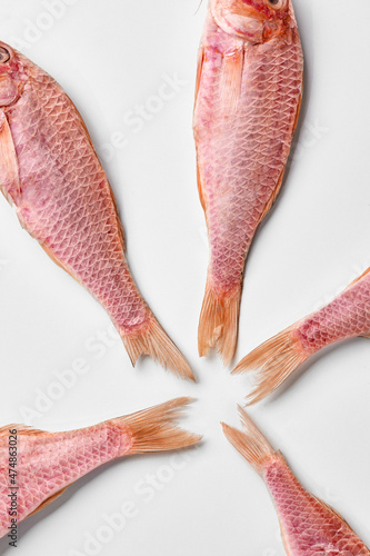 Obraz na płótnie Five air-dried red mullets tails arranged on white background