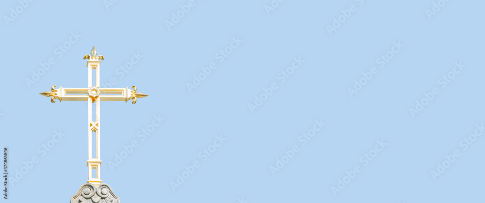 Banner with ancient monastery golden cross at blue sky solid background with copy space. Concept of religious and historic heritage. Banner with ancient monastery golden cross at blue sky solid background with copy space. Concept of religious and historic heritage.
