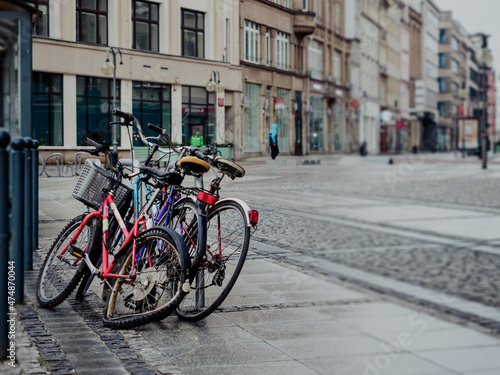 abandoned broken obsolete three bicycles on city street in a rainy day © lenaivanova2311