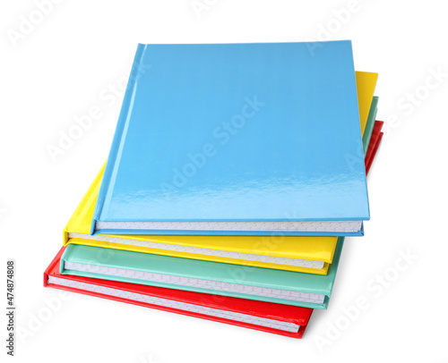 Foto Stack of different colorful hardcover planners on white background