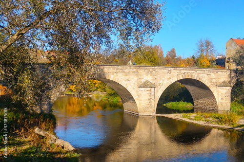 Beautiful old bridge over the river on a sunny day.