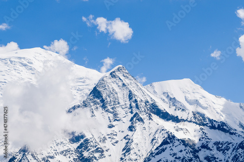 Clouds over Mont Blanc, Aiguille de Bionnassay and Aiguille du Gouter in Europe, France, the Alps, towards Chamonix, in summer, on a sunny day.