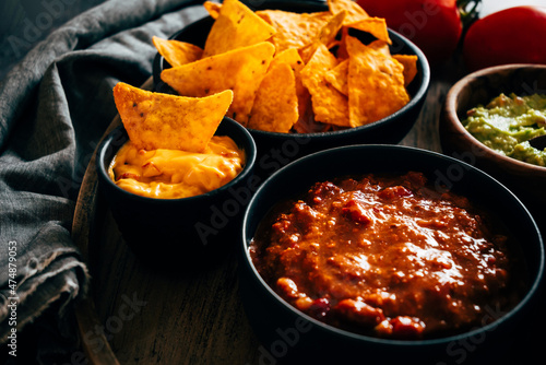 Mexican nachos with guacamole, cheddar cheese and chili.