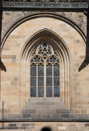 Gothic style window on the wall of an old temple.