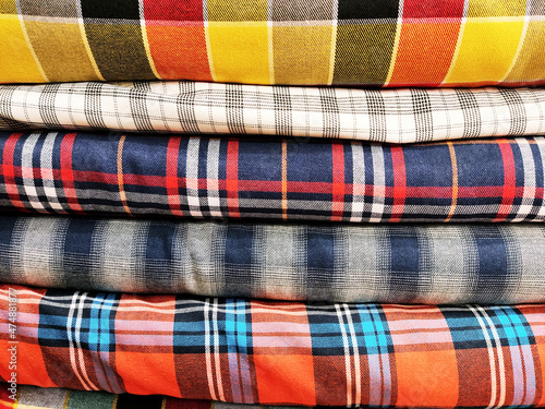 showcase of fabrics. Pile of silk clothes. set of fabrics for sewing clothes, creativity, needlework, fabrics. Hobby and tailor shop showcase with fabrics and for clothes.