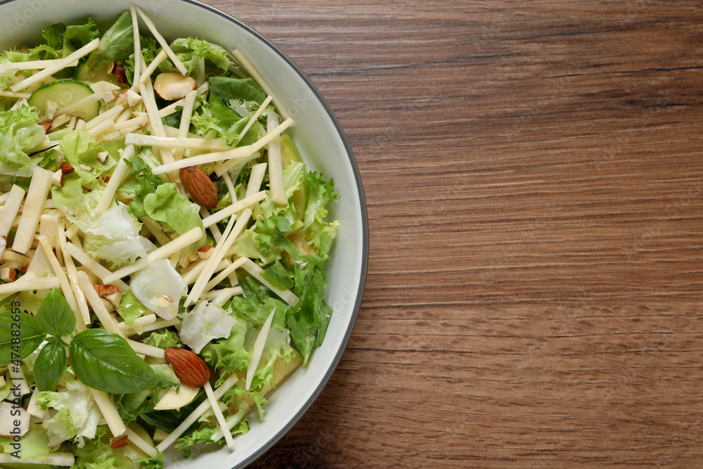 Delicious turnip salad served on wooden table, top view. Space for text Delicious turnip salad served on wooden table, top view. Space for text