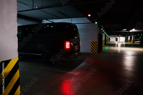 Black van in parking garage at night photo