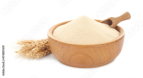 Semolina and scoop in wooden bowl on white background