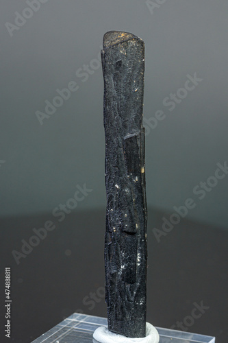 macro mineral stone Ilvaite on a gray background photo