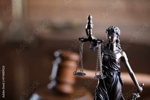 Judge office. Law and justice symbols composition: judge’s gavel, scale and Themis sculpture. © zolnierek