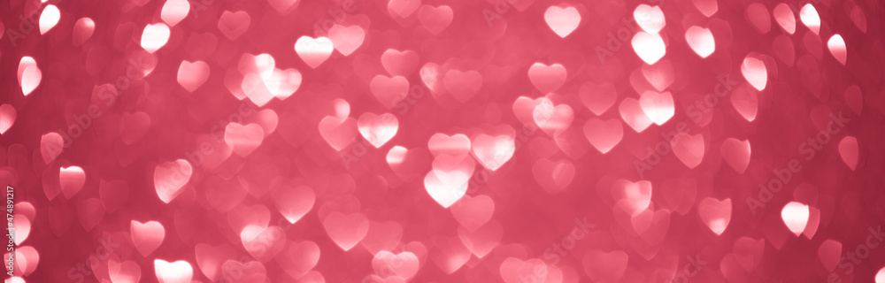 Background bokeh in the form of hearts of red and pink color. Copy space for text. The concept of romance and love. Valentine's Day. Shiny texture background. Festive background.