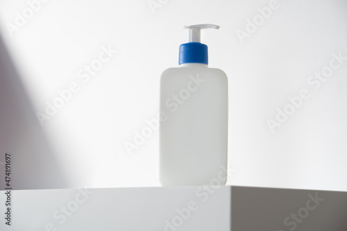 Blank cream bottle on white background