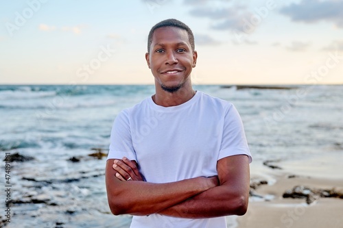 Outdoor portrait of smiling young African American man looking in camera