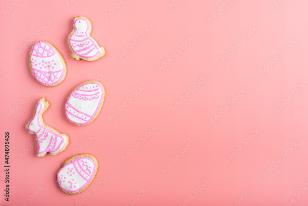 Homemade Easter cookies on pink background flat top view