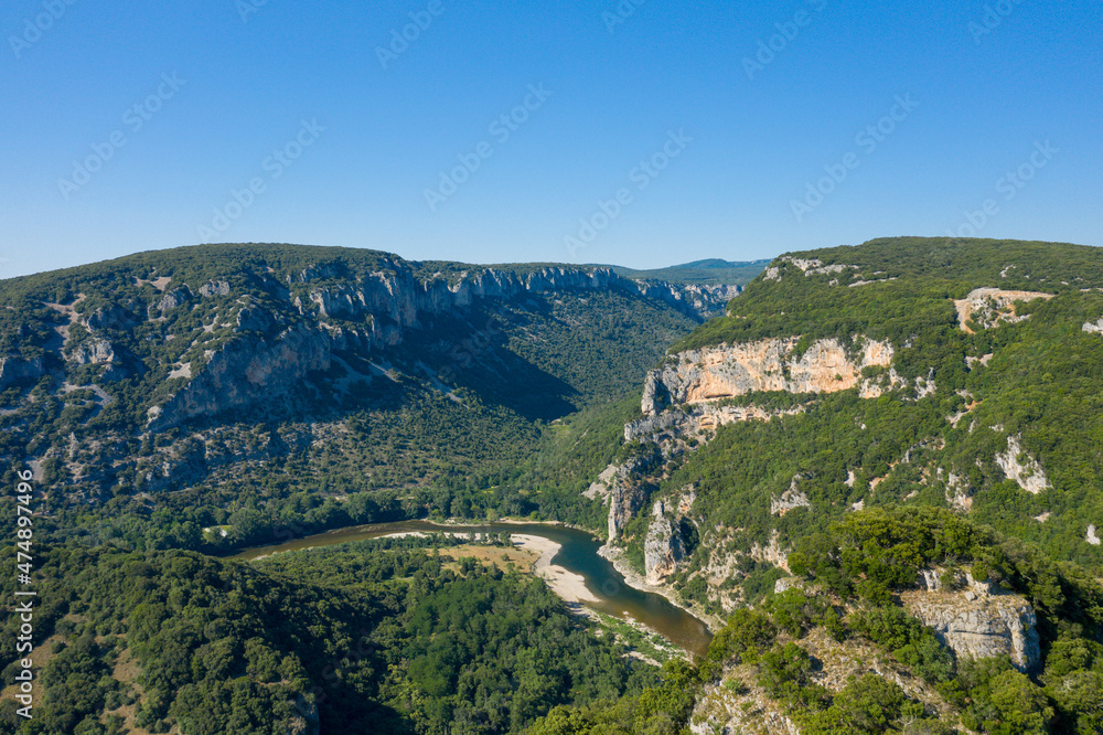 The towering green cliffs in the middle of the Gorges de lArdeche in Europe, France, Ardeche, in summer, on a sunny day.