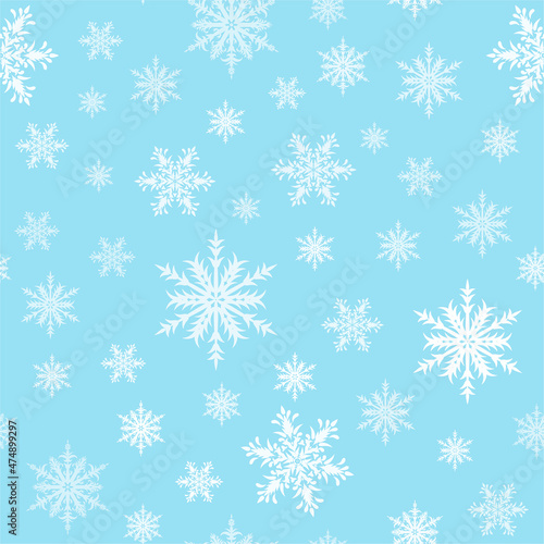 Ornamental snowflakes on light blue background seamless pattern